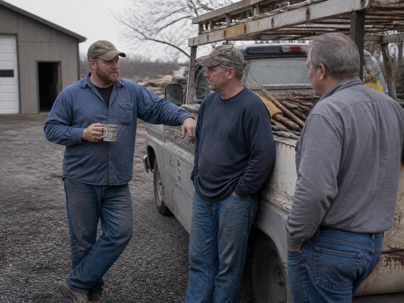 R & D PropertyWorks crew talking beside a work truck